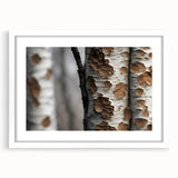 Abstract art print featuring close-up views of trees in muted green and brown tones, framed in white.