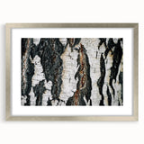 Textured art print of abstract tree designs in earthy green tones on a silver-framed canvas, suitable for bedroom decor.