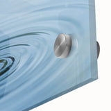 Large abstract wall art on acrylic glass depicting water ripples in muted blue tones, suitable for dining room decor.