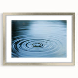 Textured art print featuring abstract blue and green water patterns, framed in silver, ideal for bedroom art.
