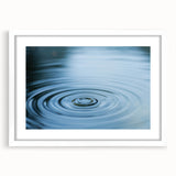 Abstract art print featuring close-up water design in muted blue and white tones on a framed canvas.