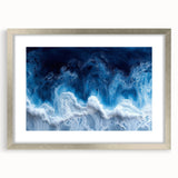 Textured abstract art print featuring close-up water design in muted blues and grays on a silver-framed mat.