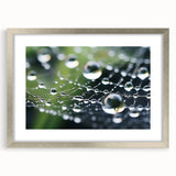 Textured abstract art print depicting rippling water, in muted blue and silver hues, framed with a silver mat.