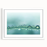 Abstract art print featuring swirling blue and green patterns on a white framed canvas, ideal for dining room decor.