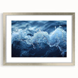 Textured art print of abstract water design in silver frame with mat, featuring cool blue and gray tones.