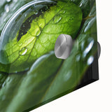 Acrylic glass print of a large abstract water motif in cool blue and green shades.