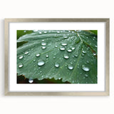 Textured art depicting abstract water design in muted blue and silver, framed with a silver mat, ideal for bedroom decor.