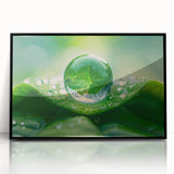 Large abstract wall art depicting water ripples in muted blue and gray, framed in black acrylic.