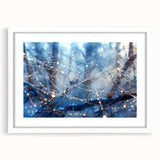 Abstract art print featuring close-up water patterns in blue and white, framed with a white mat.
