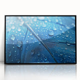 Large abstract wall art featuring swirling blue and green tones on acrylic, framed in black.