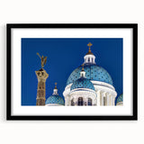 Colorful abstract art print featuring a textured cathedral design in vibrant hues on a large black-framed canvas.