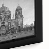 Close-up of a black framed canvas featuring a textured, colorful church design.