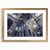Textured abstract art print depicting a stylized church, in soft gold and white tones, framed with a gold mat.