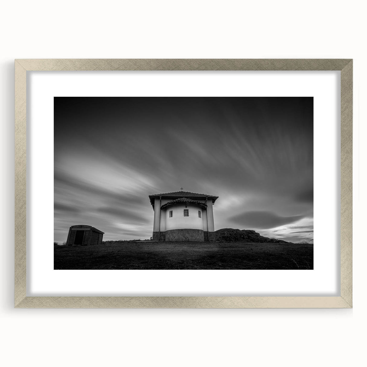 Abstract art print of a church in muted gray and blue tones, framed in silver, ideal for dining room decor.