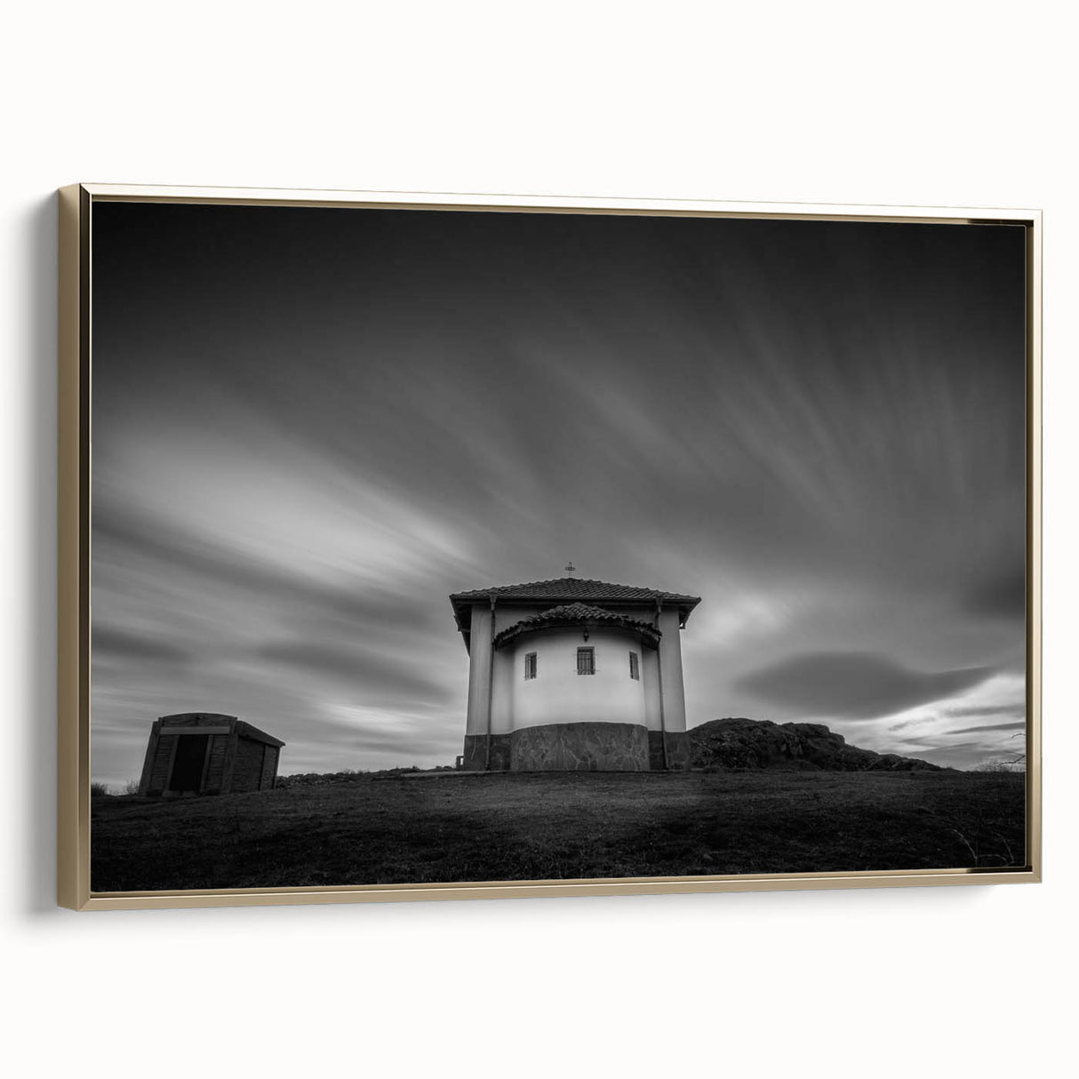 Framed canvas featuring a vintage-style landscape painting of a church with a black and colorful palette.