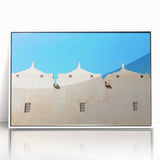 A large art print of a mid-century modernist mosque in muted earth tones, framed in white acrylic.