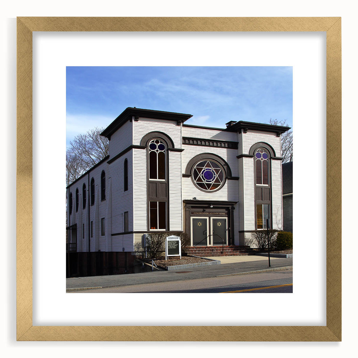 Textured abstract art print of a synagogue in muted gold and beige tones, framed with a gold mat.