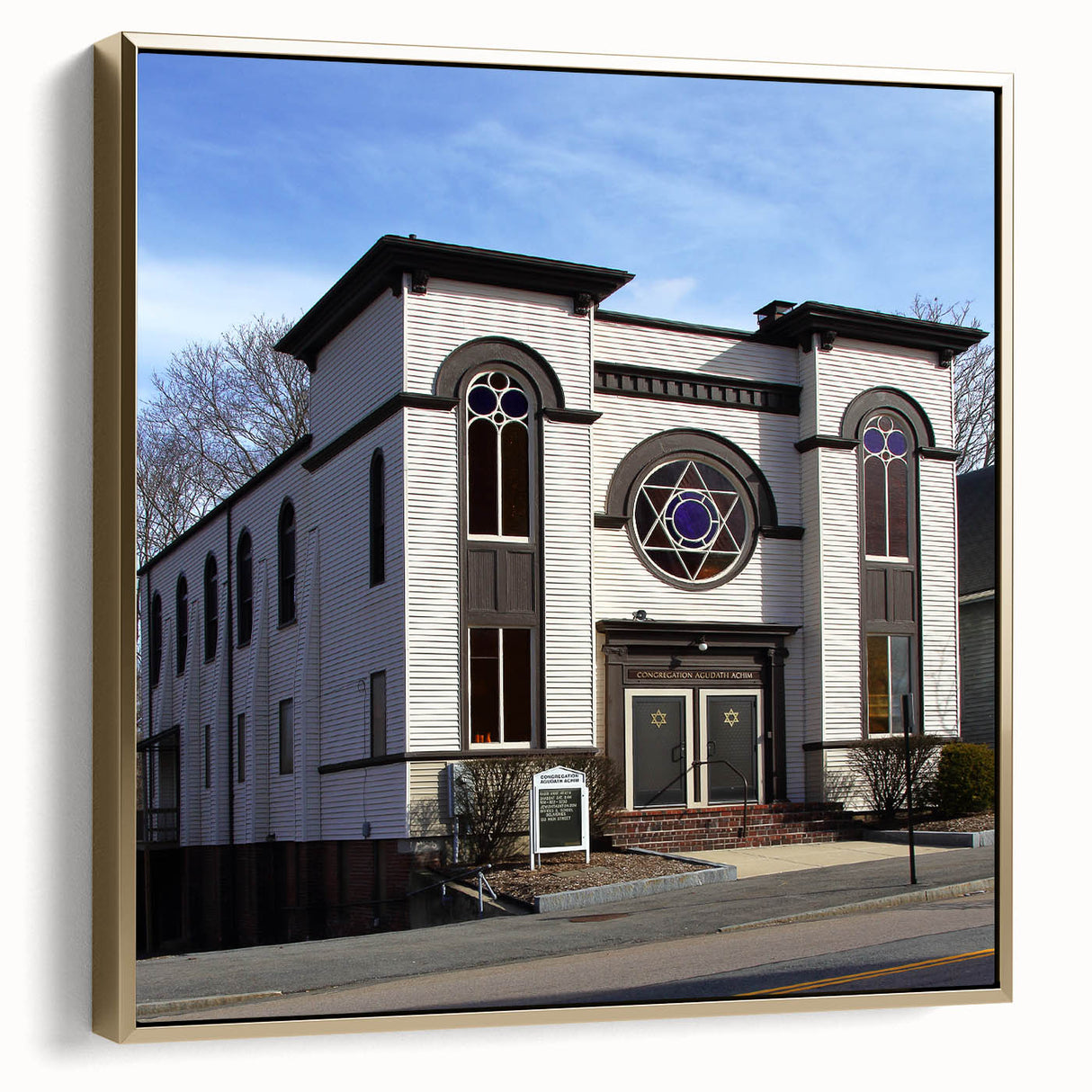 Framed canvas featuring a vintage poster of a colorful synagogue landscape in silver and gold tones.