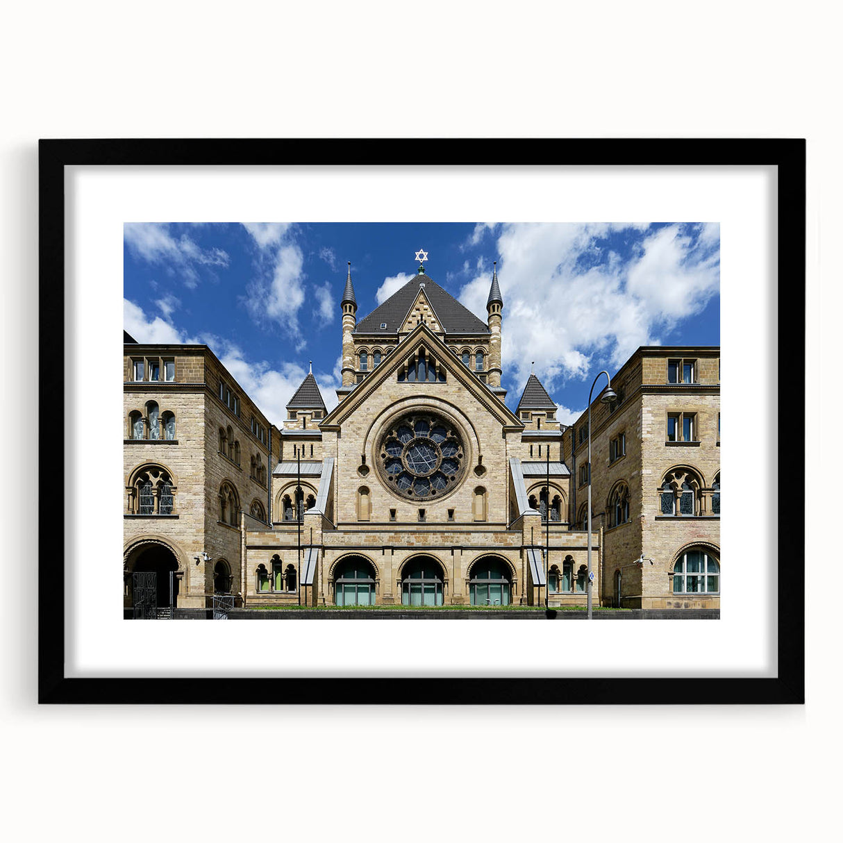 Abstract art print featuring a colorful, textured synagogue design in a black frame with mat.