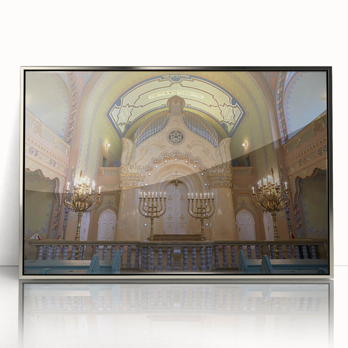 Art deco poster of a synagogue in silver frame, featuring geometric shapes and a monochrome palette.