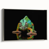 Framed wall art featuring a colorful chameleon design on a canvas, with a sleek silver frame, set against a neutral backdrop, perfect for reptile enthusiasts and modern decor.