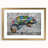 Charming chameleon wall art piece with a gold frame and mat, showcasing vibrant colors and intricate details, perfect for enhancing home decor.