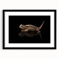 Framed wall art featuring a vibrant reptile lizard design in bold colors, set in a sleek black frame with a mat, perfect for enhancing modern home decor.