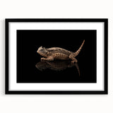 Framed wall art featuring a vibrant reptile lizard design in bold colors, set in a sleek black frame with a mat, perfect for enhancing modern home decor.