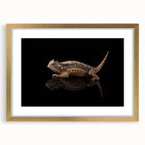 Framed wall art featuring a vibrant lizard design in gold tones, set against a sleek mat, perfect for reptile enthusiasts and modern decor styles.