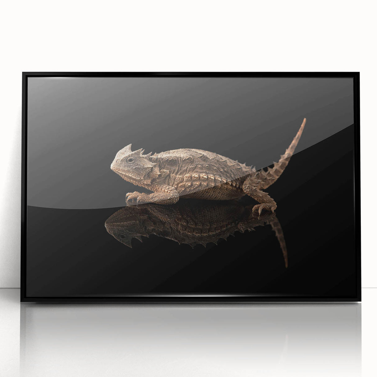 Framed wall art featuring a vibrant lizard design, showcasing intricate details in bold colors with a sleek black frame, perfect for reptile enthusiasts' decor.