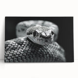 Stretched canvas wall art featuring a vibrant snake design in shades of green and black, leaning against a neutral wall, perfect for reptile enthusiasts' decor.
