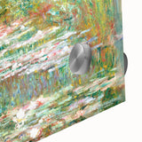 Large abstract wall art of Monet-inspired scenery in muted blues and greens on acrylic glass, ideal for dining room ambiance.