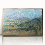 Large art print of a Paul Cézanne landscape in a gold frame, featuring muted earth tones.