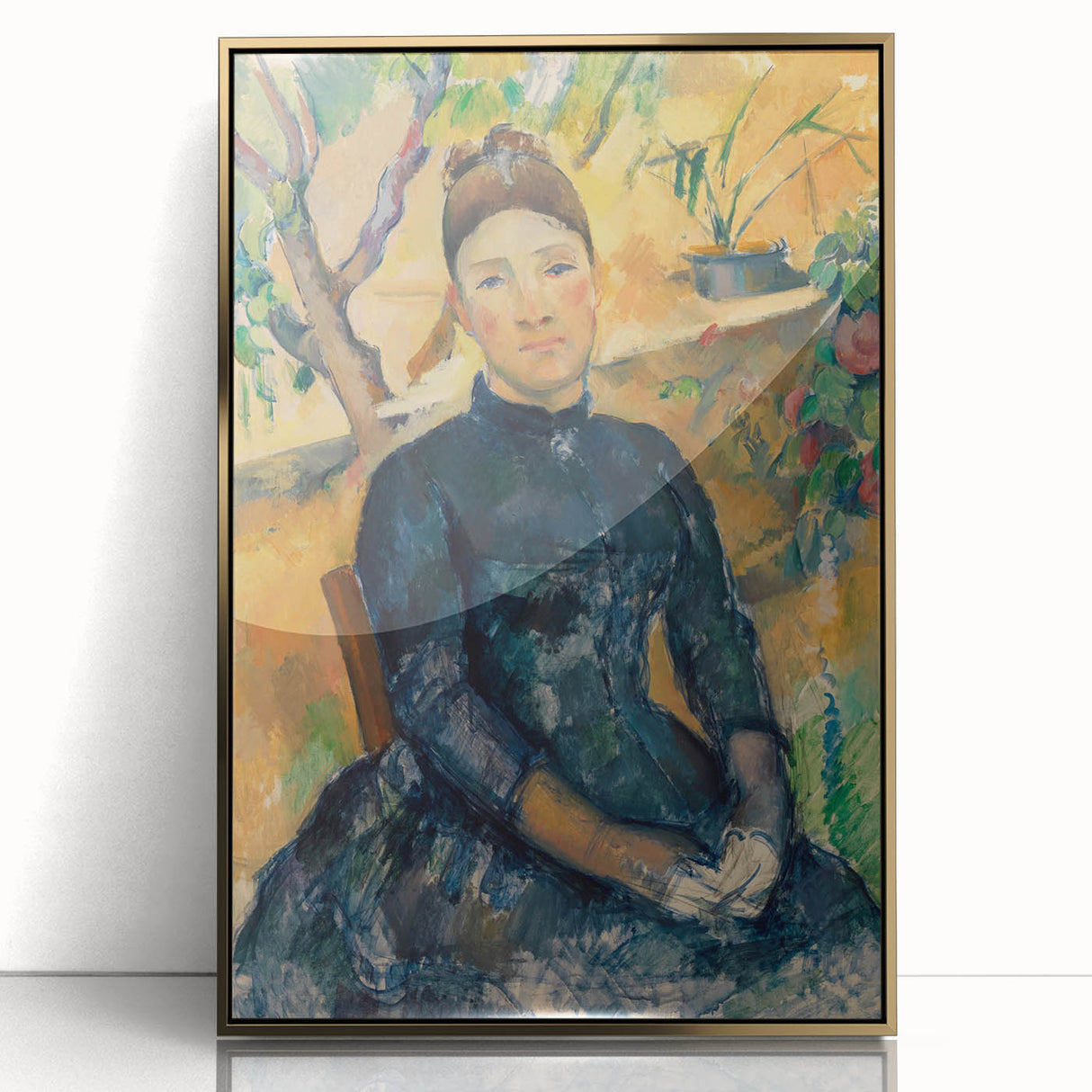 Large art print of a Paul Cézanne landscape in muted earth tones, framed in gold acrylic.
