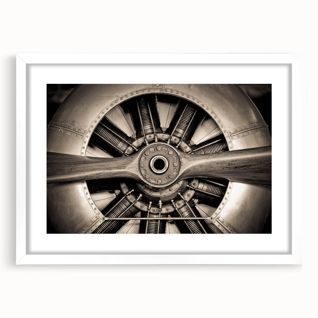 Extra large abstract art print of a textured airplane, in muted gray tones, framed with a white mat.