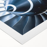 Art deco poster of an airplane with geometric shapes in navy and gold, on rolled canvas.