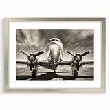 Textured art print of abstract airplane design in silver and gray tones, framed with a silver mat, suited for bedroom decor.