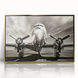 Large abstract wall art featuring a mid-century modernist airplane design in gold and white tones on a framed acrylic panel.