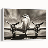 Framed canvas featuring a vintage poster art of a black airplane with colorful accents.