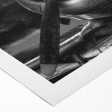 Art deco poster of an airplane in flight, featuring bold geometric shapes and a monochrome palette on rolled canvas.