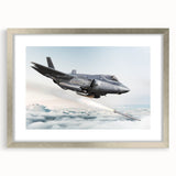 Abstract art print of an airplane in muted gray and blue tones, framed in silver, suitable for bedroom or dining room decor.