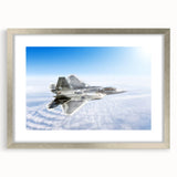 Abstract art print featuring a textured depiction of an airplane, in muted gray and silver, framed with a silver mat.