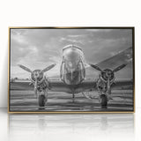 Framed acrylic print featuring large abstract wall art of an airplane in gold and black tones.