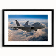 Abstract art print of an airplane in muted gray and black tones on a framed canvas.