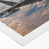 Art deco poster of a vintage airplane in muted beige and brown, printed on rolled canvas.