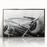 Large abstract wall art featuring a mid-century modernist airplane design in gold and black tones on a framed acrylic panel.