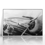 Mid-century modernist art featuring an airplane in muted blue and gray tones on a white acrylic frame.