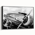 Black and white framed canvas featuring a vintage airplane side view, suitable as wall art for a bedroom.