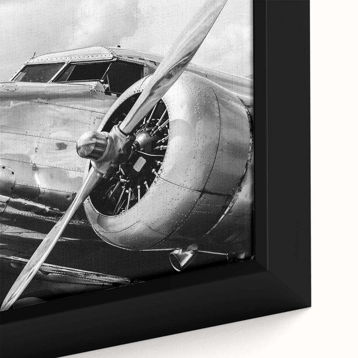 Extra large framed canvas featuring a textured depiction of a black airplane with colorful accents.