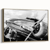 Framed canvas featuring a vintage poster of a golden airplane on a black background, ideal for an office or study room.